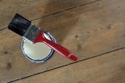 picture of a paintbrush resting on a pot of paint